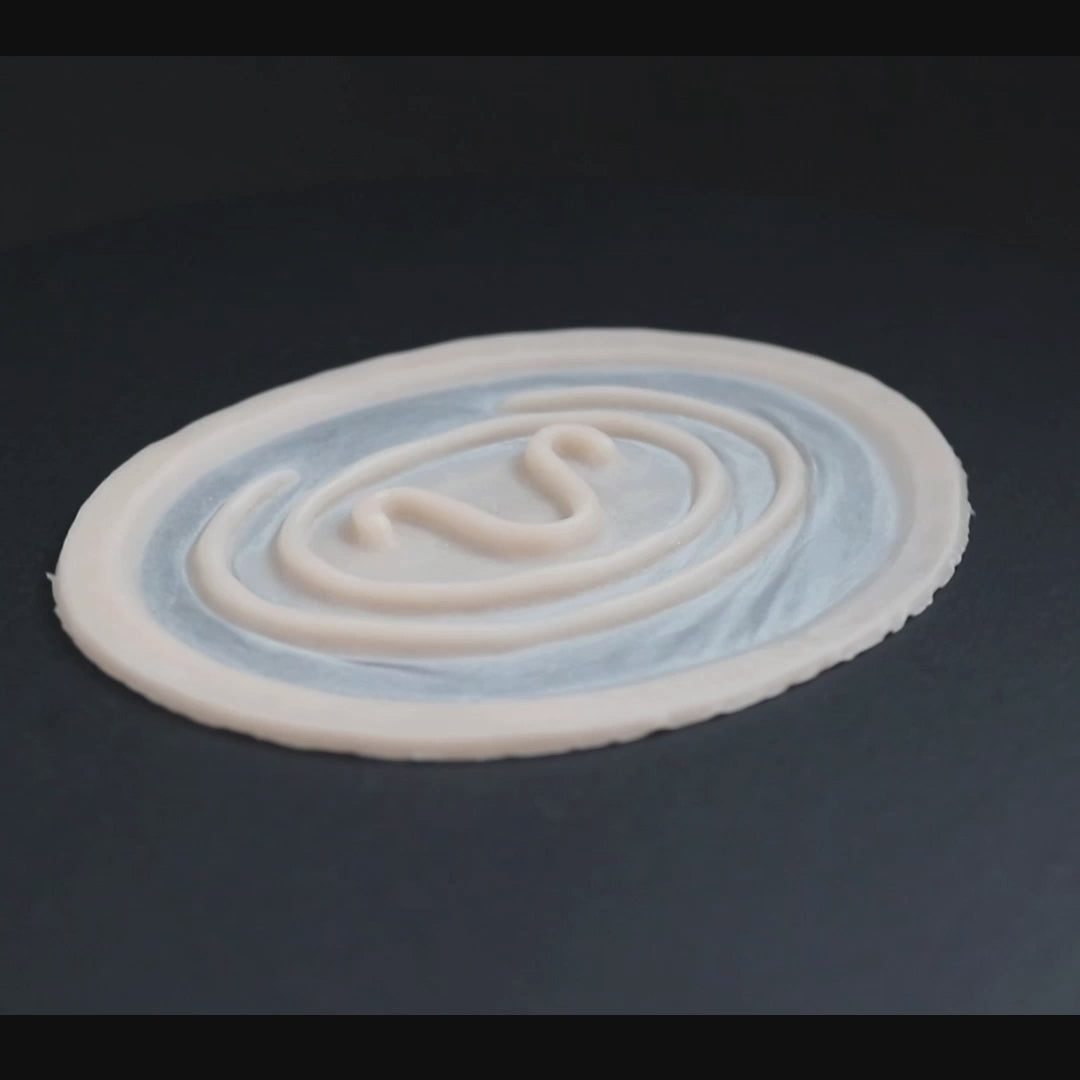 Goa'uld mark prosthetic in vanilla shade on a black turntable, slowly rotating.