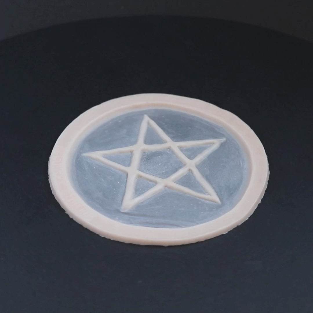 Pentagram prosthetic in vanilla shade on a black turntable, slowly rotating.