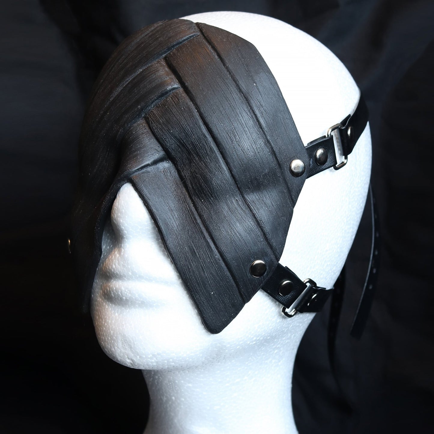 Black silicone blindfold on a white mannequin