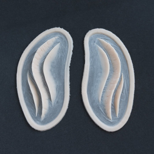 Mermaid Gills (Pair) - Silicone makeup prosthetic in vanilla shade on a black surface