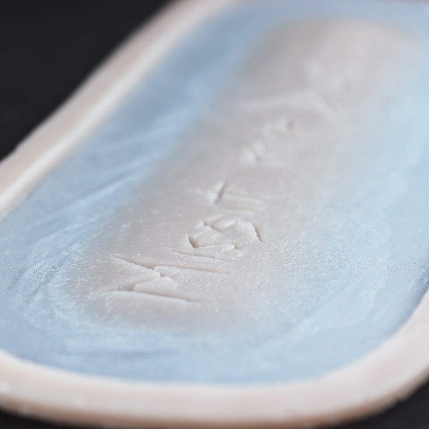 Missit Me Dominus Carving (The Lord Has Sent Me) - Silicone makeup prosthetic in vanilla shade on a black surface