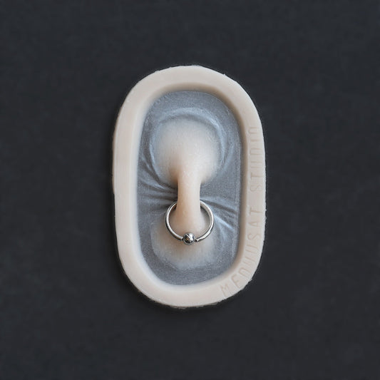 Nose Bridge - Silicone makeup prosthetic in vanilla shade on a black surface