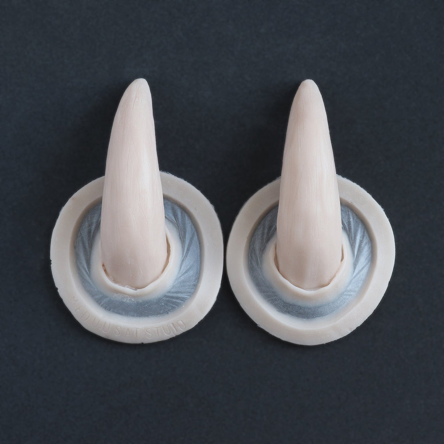 Oni Horns - Silicone makeup prosthetic in vanilla shade on a black surface