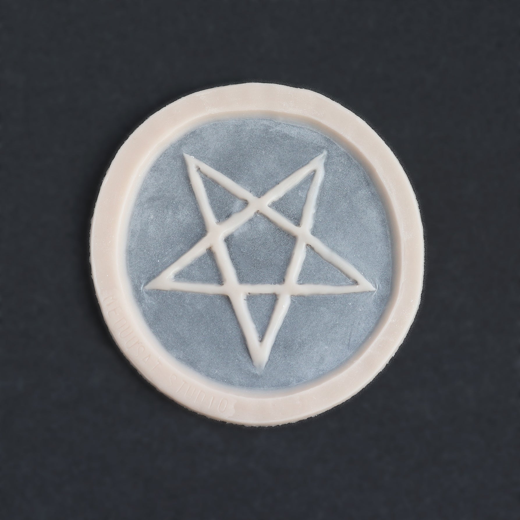 Pentagram Scarification - Silicone makeup prosthetic in vanilla shade on a black surface