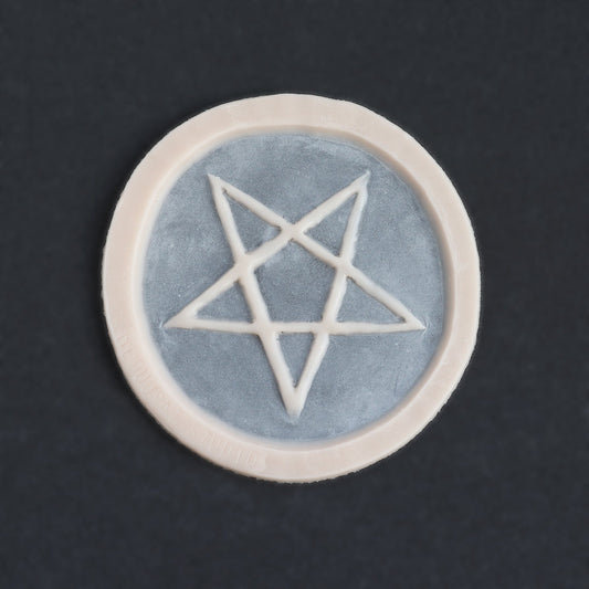 Pentagram Scarification - Silicone makeup prosthetic in vanilla shade on a black surface