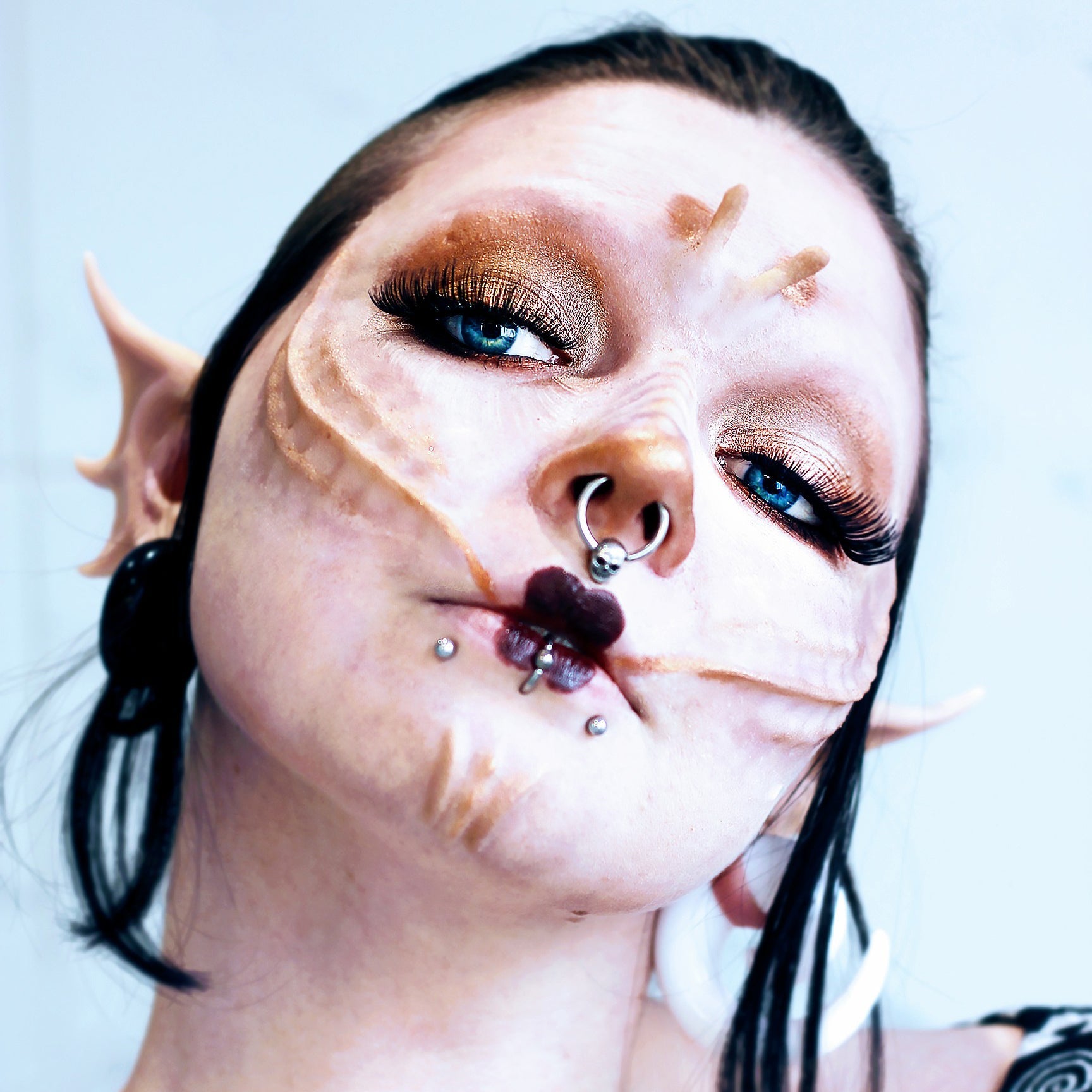 Woman with black hair wearing gold seahorse scales