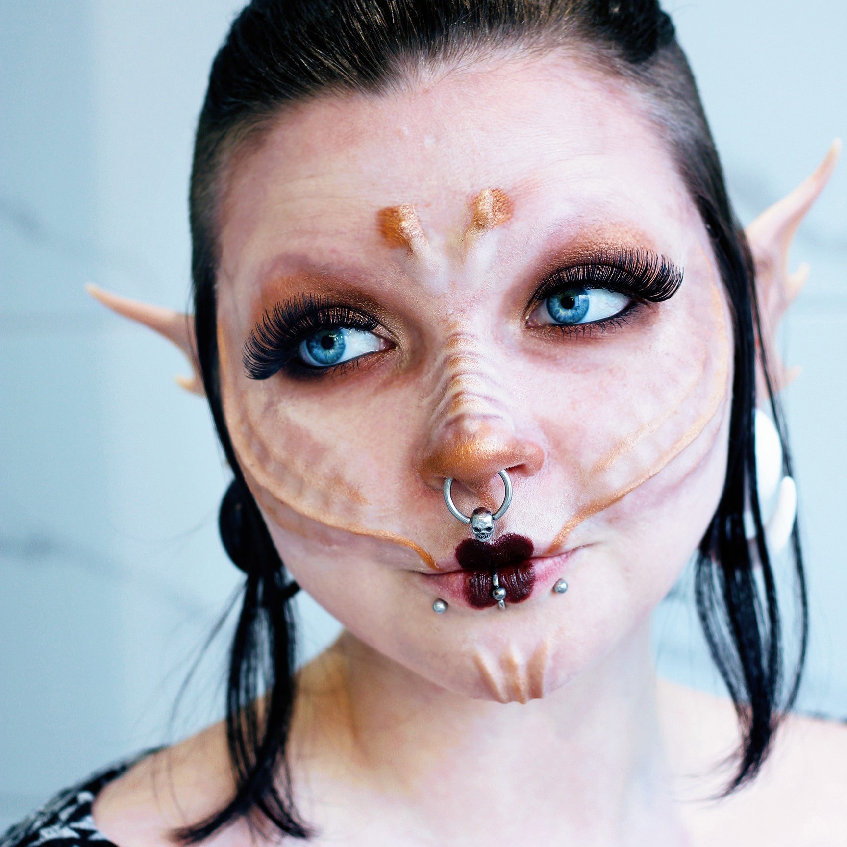 Woman with black hair wearing gold seahorse scales