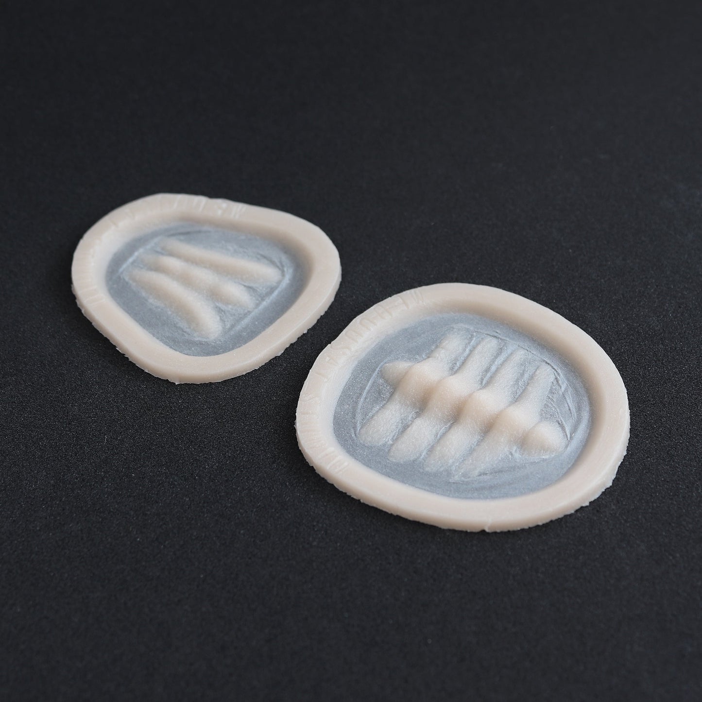 Seahorse Facial Scales - Silicone makeup prosthetic in vanilla shade on a black surface
