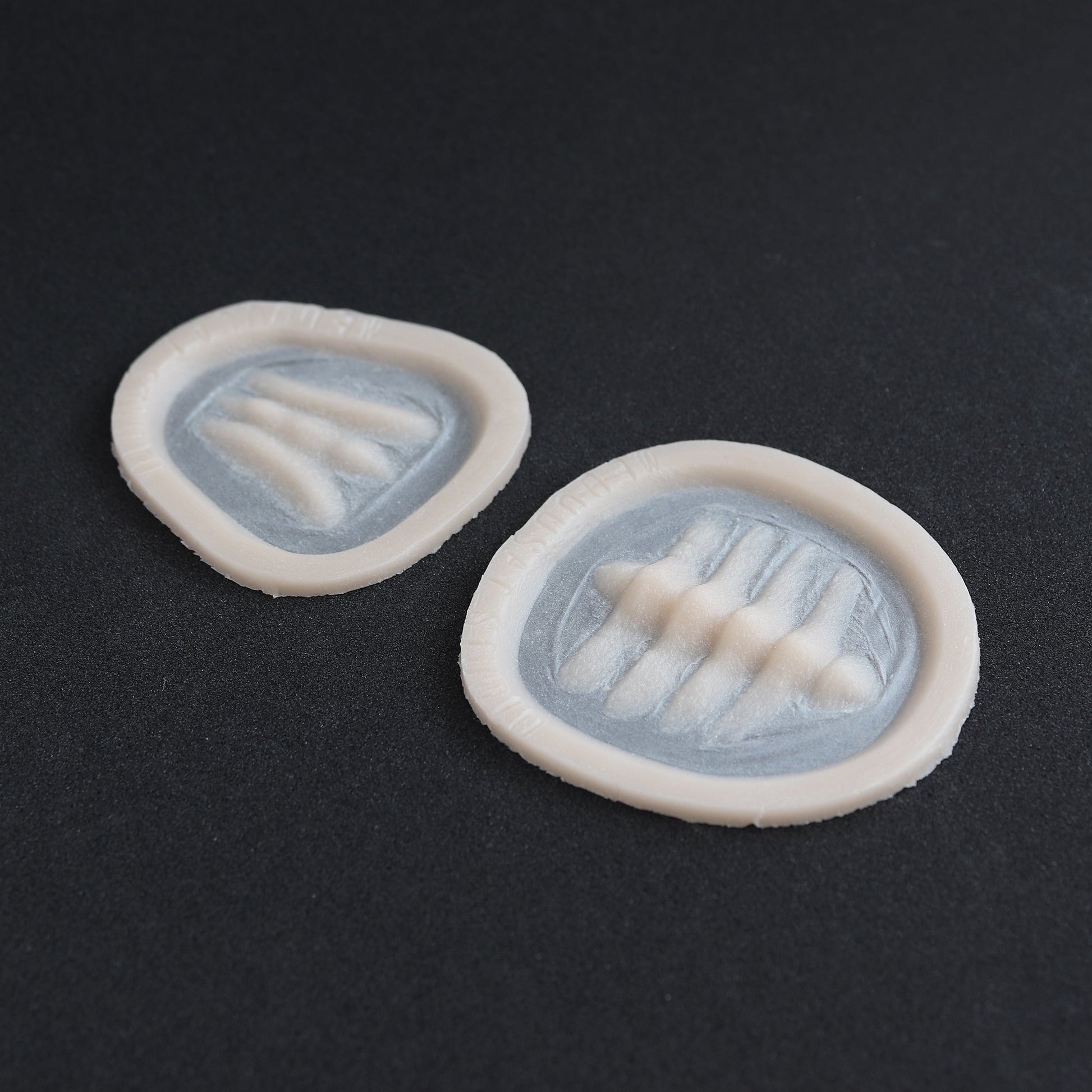 Seahorse Facial Scales - Silicone makeup prosthetic in vanilla shade on a black surface