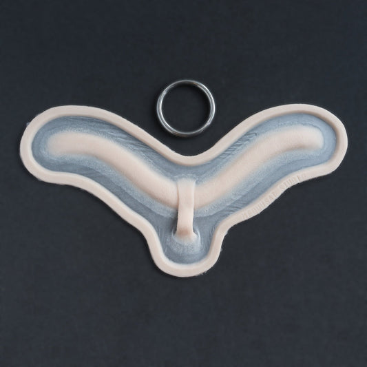 Subdermal Choker - Silicone makeup prosthetic in vanilla shade on a black surface