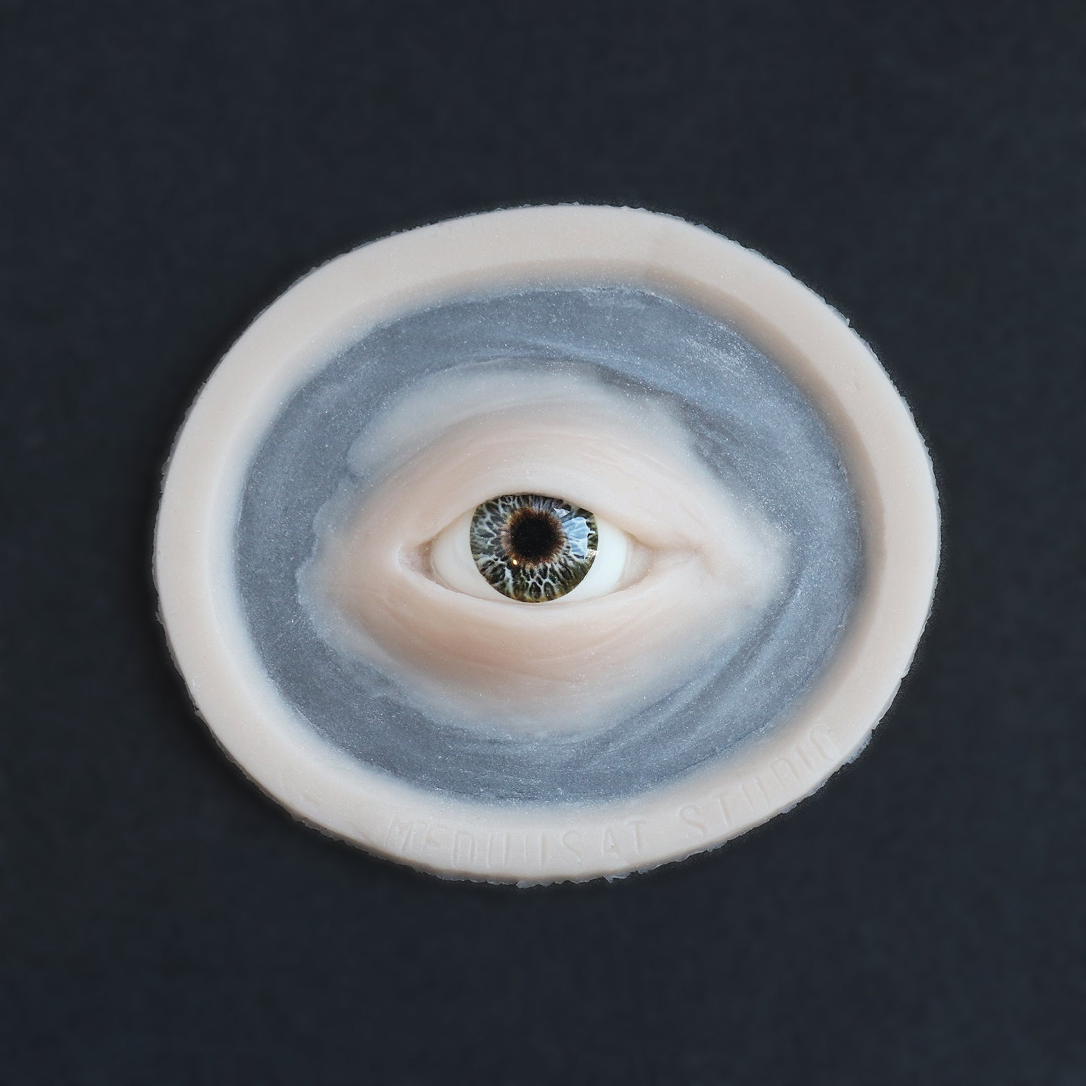 Third Eye - Silicone makeup prosthetic in vanilla shade on a black surface