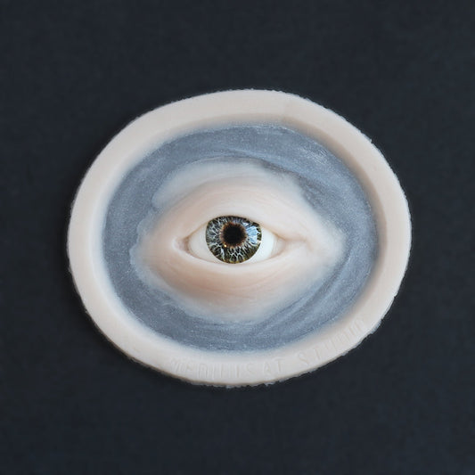 Third Eye - Silicone makeup prosthetic in vanilla shade on a black surface