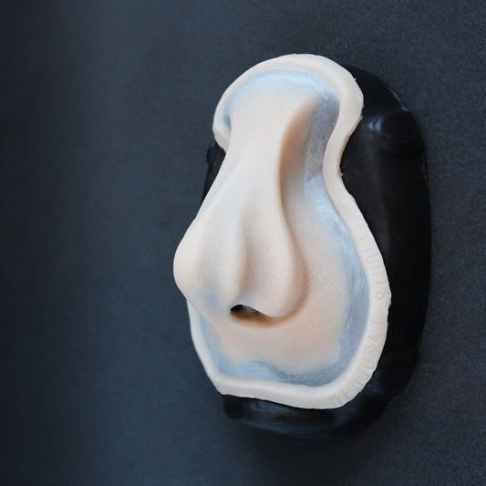 Whelk Nose - Silicone makeup prosthetic in vanilla shade on a black surface