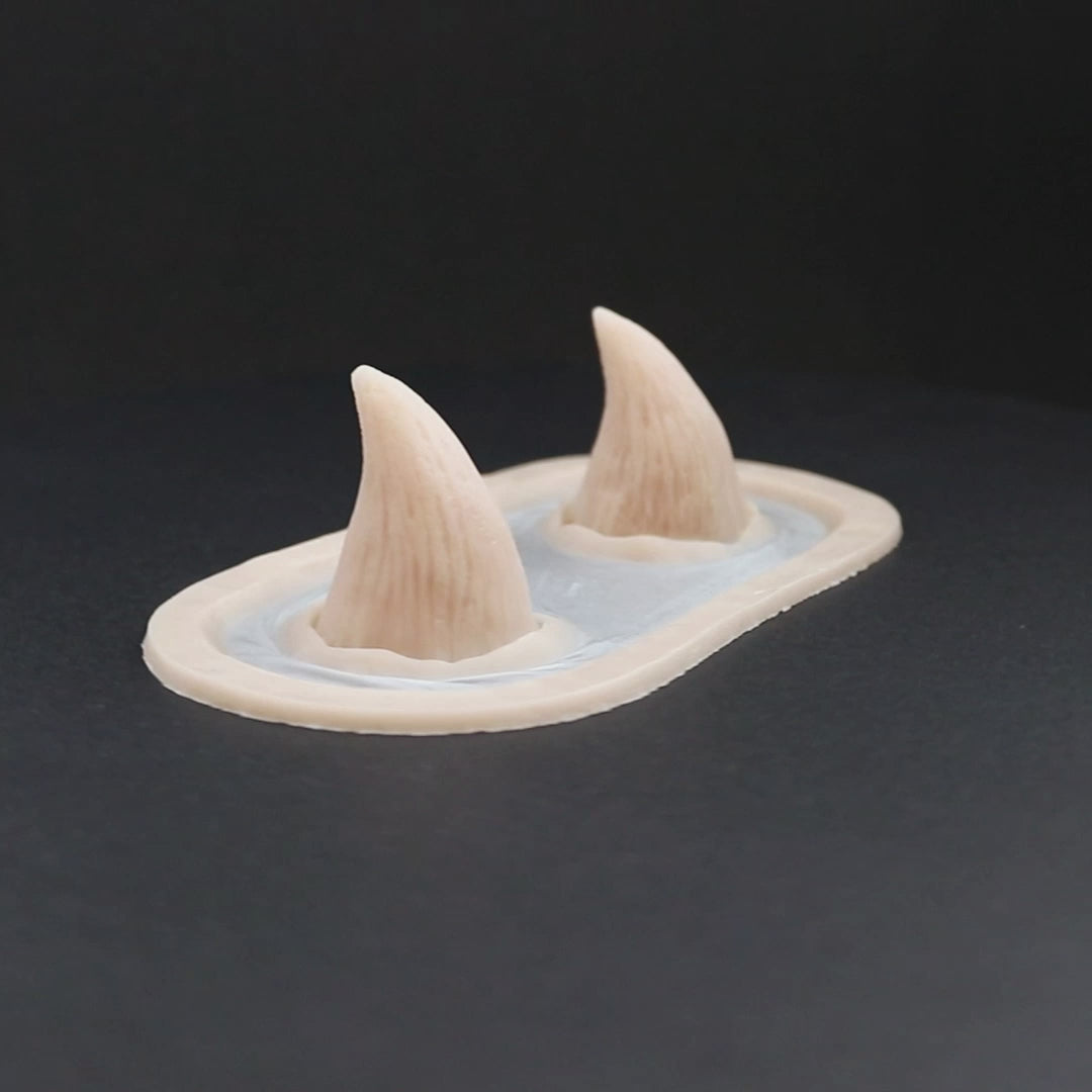 Devil Horns prosthetic in vanilla shade on a black turntable, slowly rotating. 