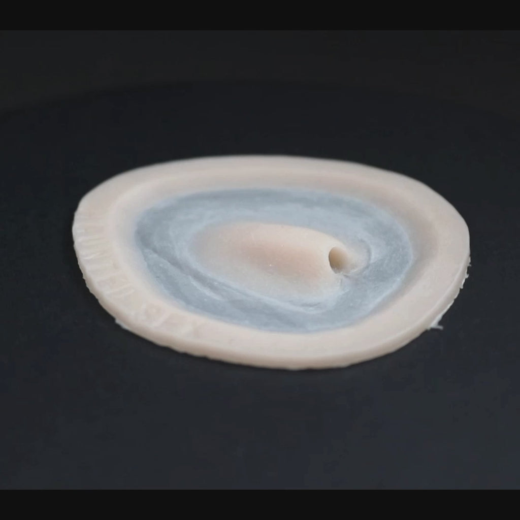 Skin pocket 1 prosthetic in vanilla shade on a black turntable, slowly rotating. 