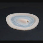 Skin pocket 1 prosthetic in vanilla shade on a black turntable, slowly rotating. 