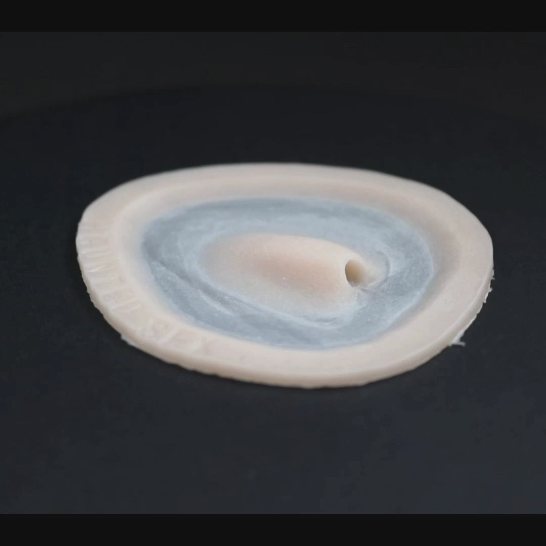 Skin pocket 1 prosthetic in vanilla shade on a black turntable, slowly rotating. 