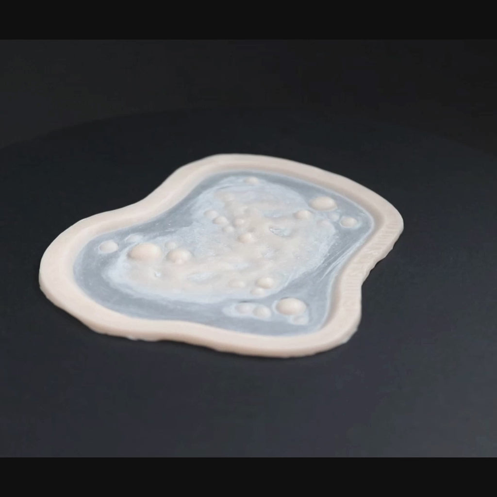 Infected Bite prosthetic in vanilla shade on a black turntable, slowly rotating. 