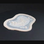 Infected Bite prosthetic in vanilla shade on a black turntable, slowly rotating. 