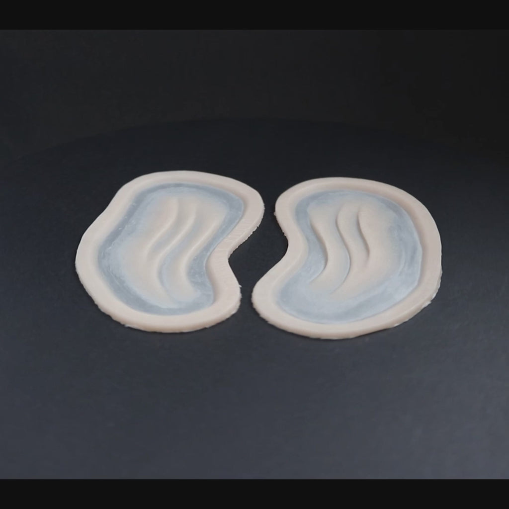 A pair of manta gills prosthetic in vanilla shade on a black turntable, slowly rotating. 