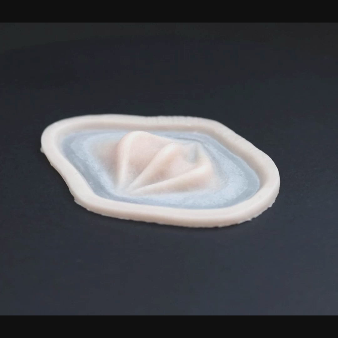 Nose ridges prosthetic in vanilla shade on a black turntable, slowly rotating. 