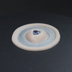 Galaxy Third Eye prosthetic in vanilla shade on a black turntable, slowly rotating. 
