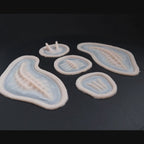 Seahorse prosthetic in vanilla shade on a black turntable, slowly rotating. 