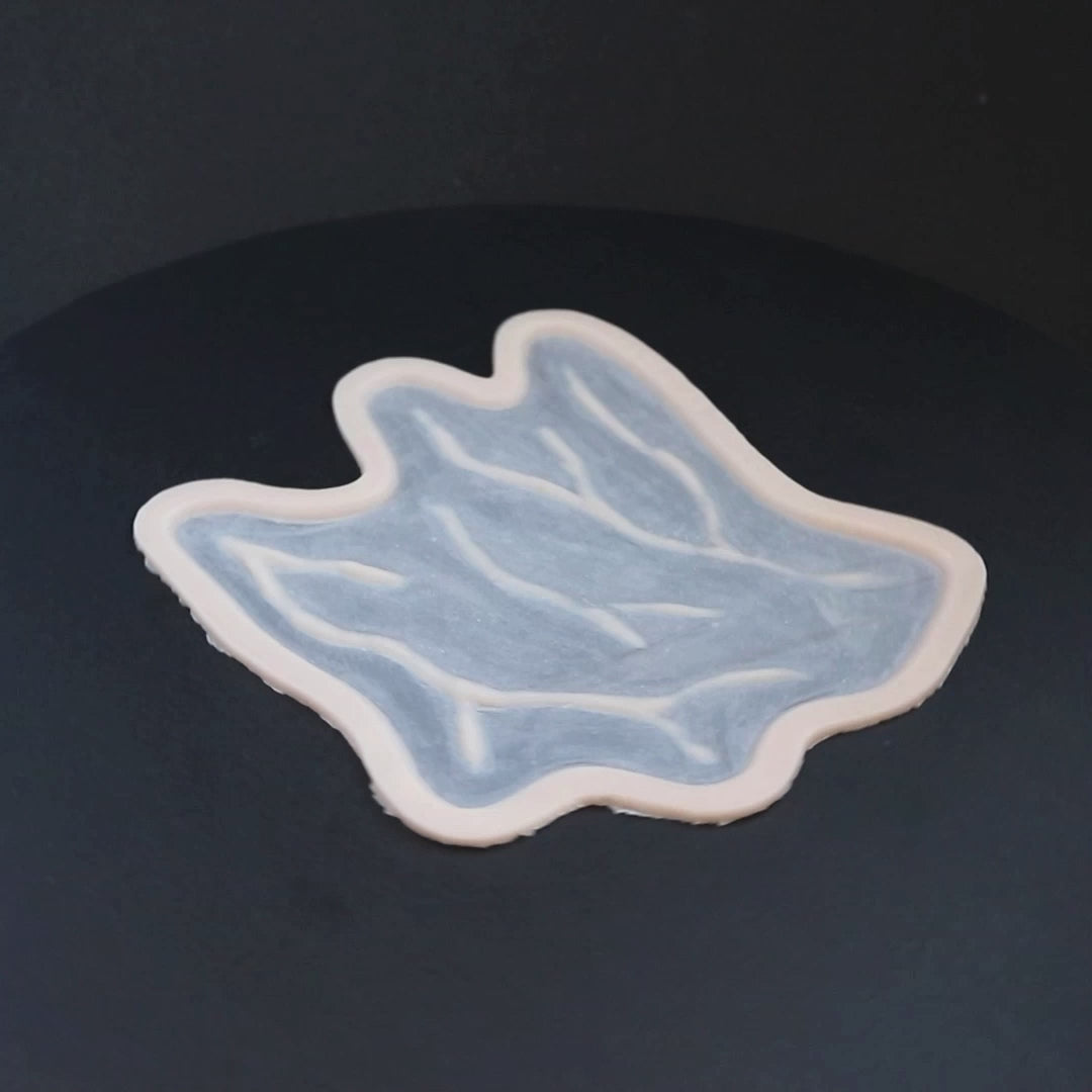 Veins C prosthetic in vanilla shade on a black turntable, slowly rotating. 