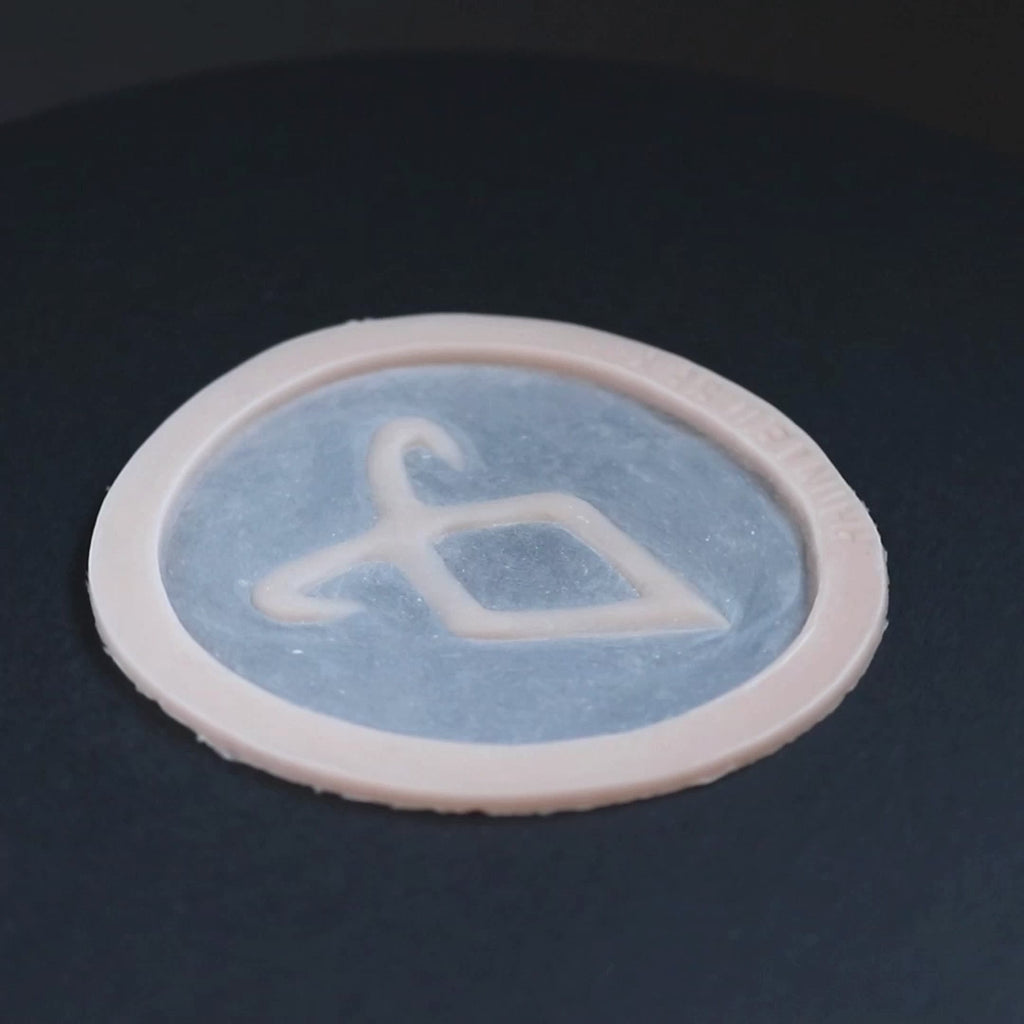 Angel Rune in vanilla shade on a black turntable, slowly rotating.