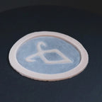 Angel Rune in vanilla shade on a black turntable, slowly rotating.