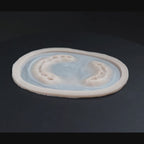 Zombie bite prosthetic in vanilla shade on a black turntable, slowly rotating. 