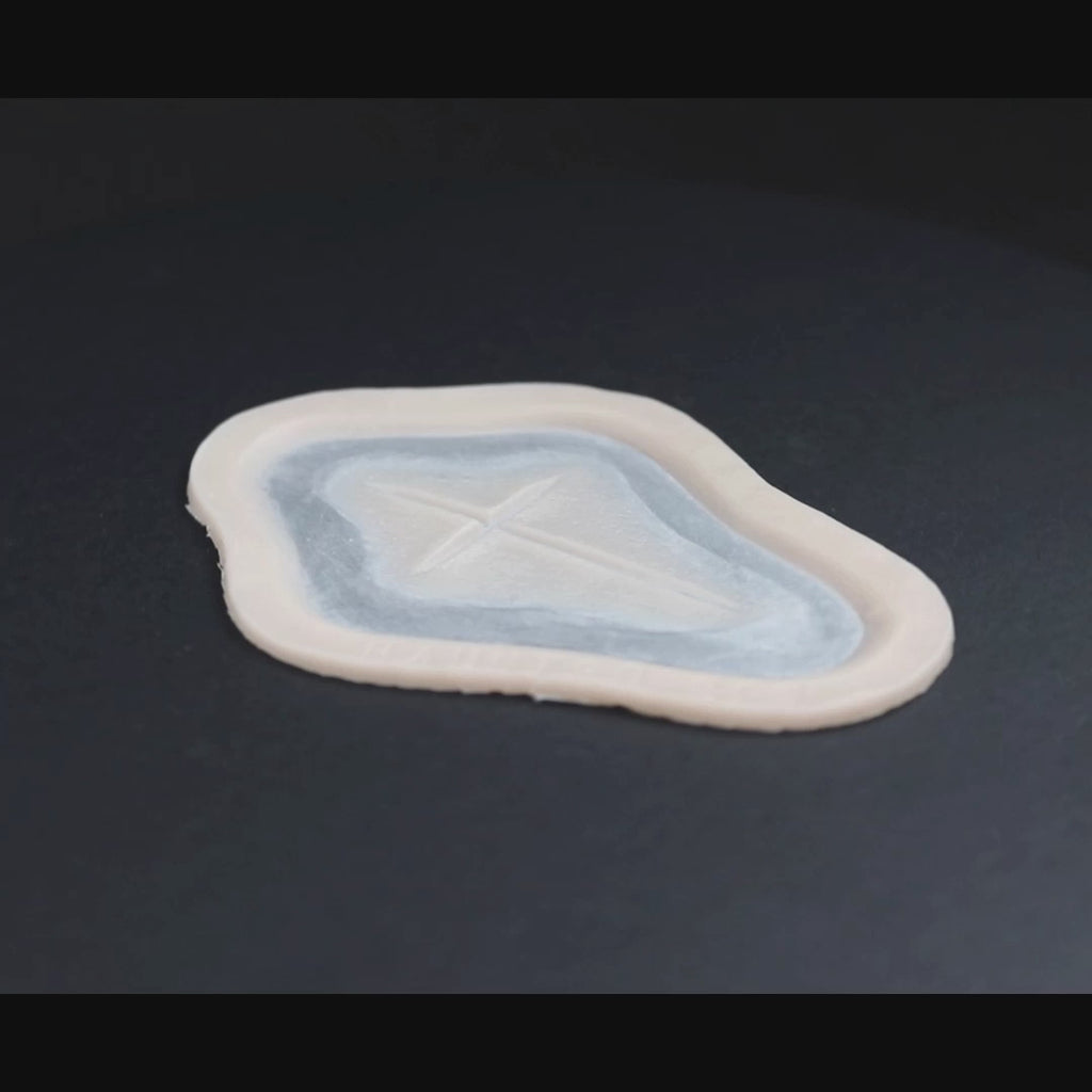 Cross Carving prosthetic in vanilla shade on a black turntable, slowly rotating. 