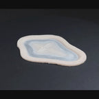 Cross Carving prosthetic in vanilla shade on a black turntable, slowly rotating. 