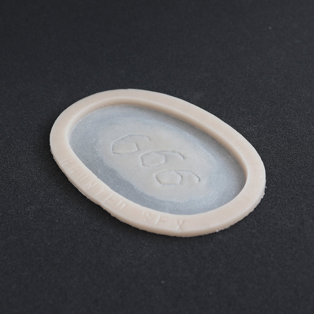 666 Carving prosthetic in vanilla shade at an angle on a black surface