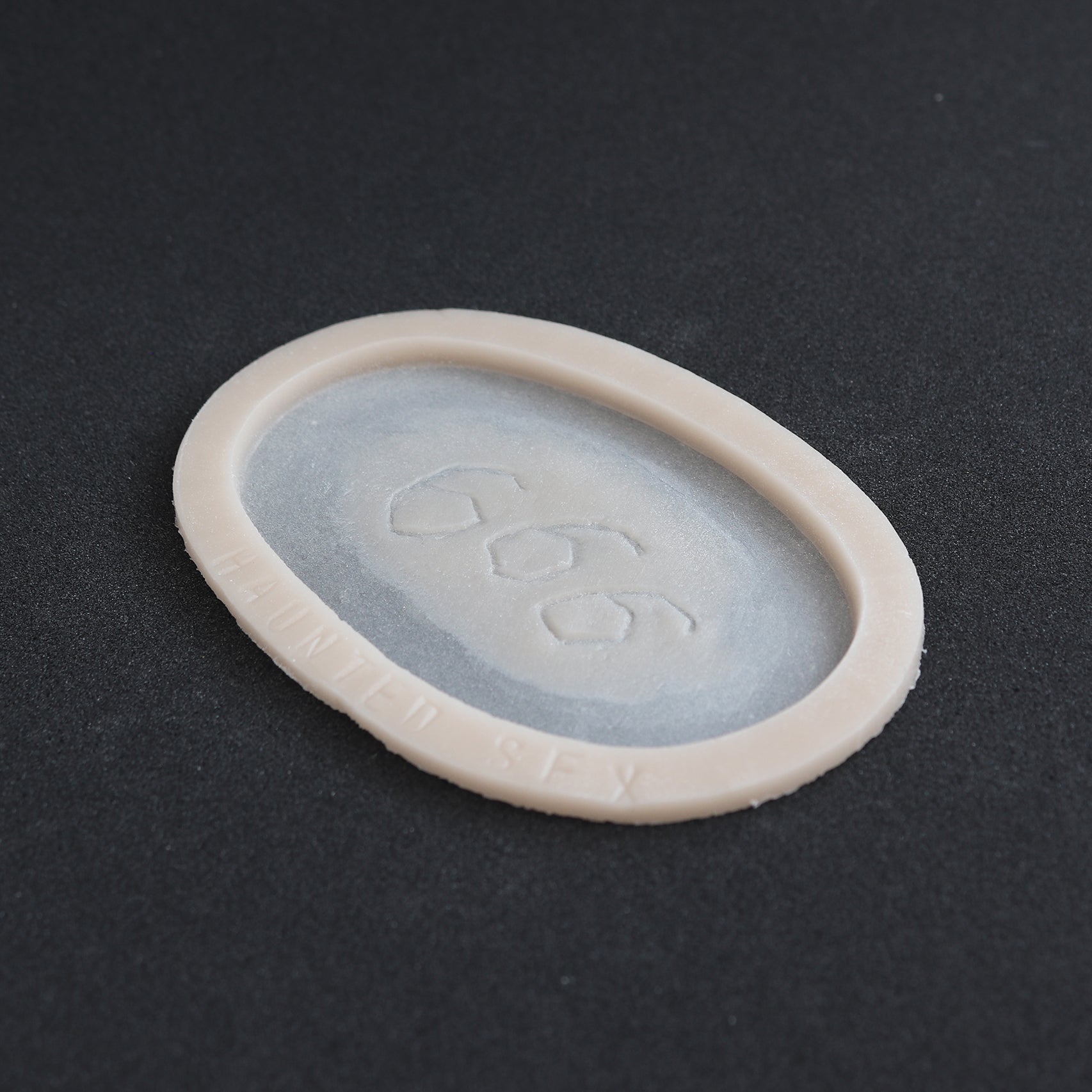 666 Carving prosthetic in vanilla shade at an angle on a black surface