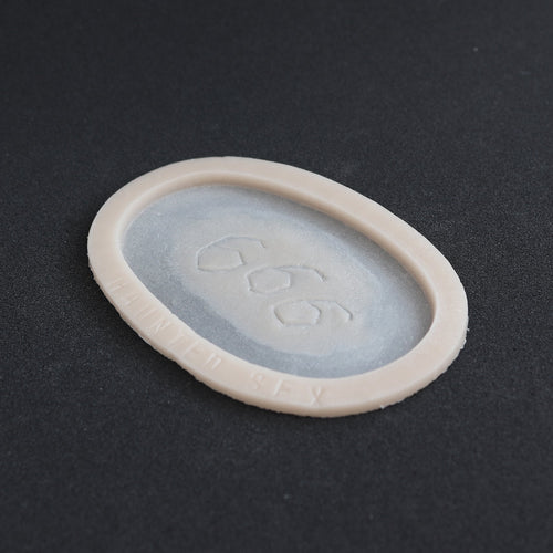 666 Carving prosthetic in vanilla shade at an angle on a black surface