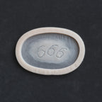 666 carving prosthetic in vanilla shade on a black surface