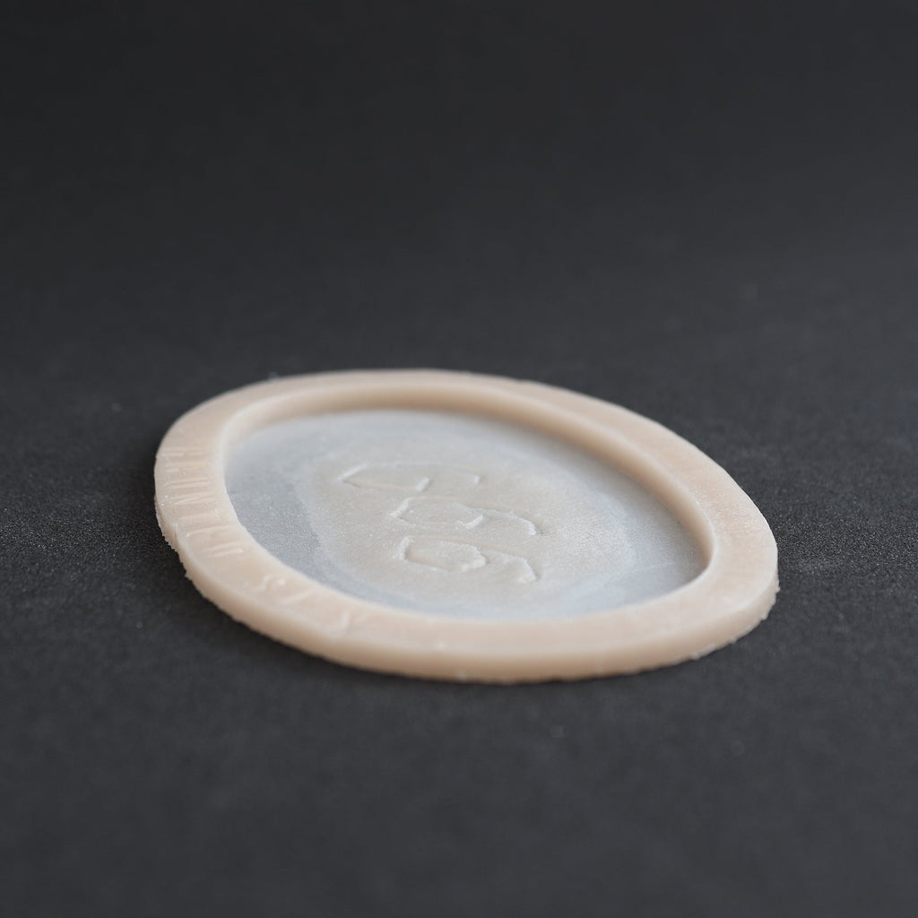 666 Carving prosthetic in vanilla shade at a steep angle on a black surface