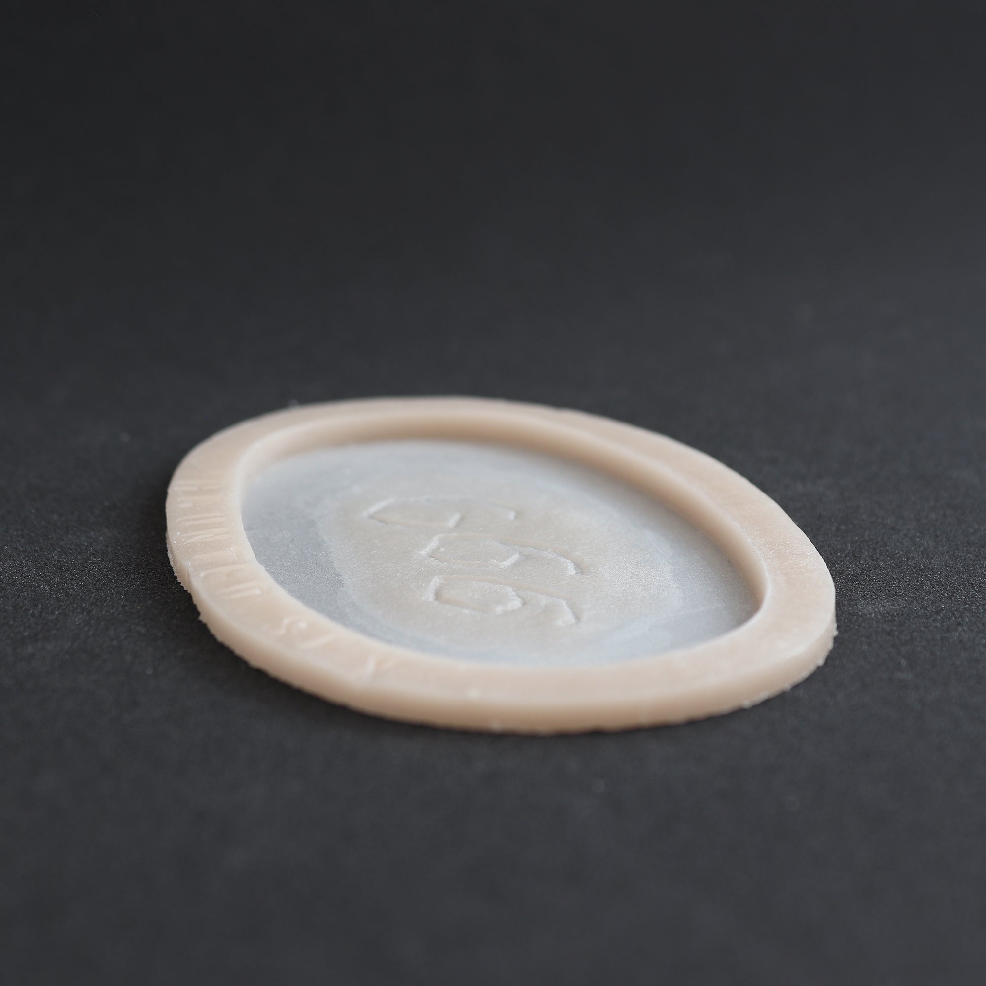 666 Carving prosthetic in vanilla shade at a steep angle on a black surface