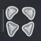 Alligator Scales temple and cheek pieces in vanilla shade on a black surface with a ruler.