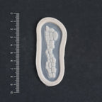 Alligator Scales nose piece in vanilla shade on a black surface with a ruler.