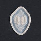 Alligator Scales neck piece in vanilla shade on a black surface.