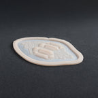 Alligator Scales neck piece in vanilla shade at an angle on a black surface.