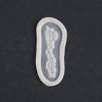 Alligator Scales nose piece in vanilla shade on a black surface.