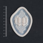 Alligator Scales neck piece in vanilla shade on a black surface with a ruler.