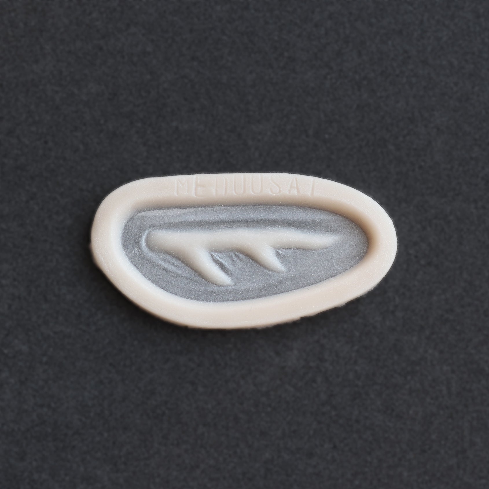 Antler Scar - Silicone makeup prosthetic in vanilla shade on a black surface