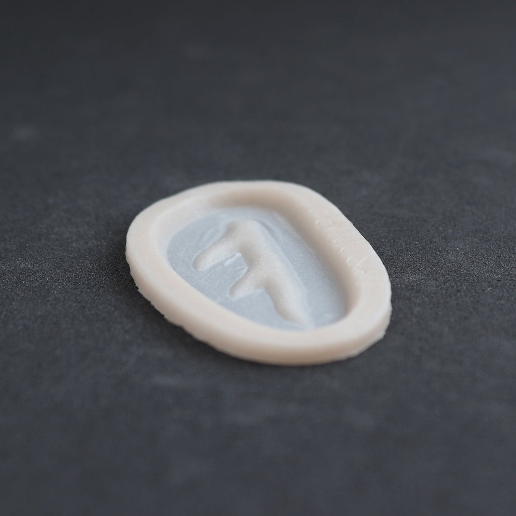 Antler Scar - Silicone makeup prosthetic in vanilla shade on a black surface