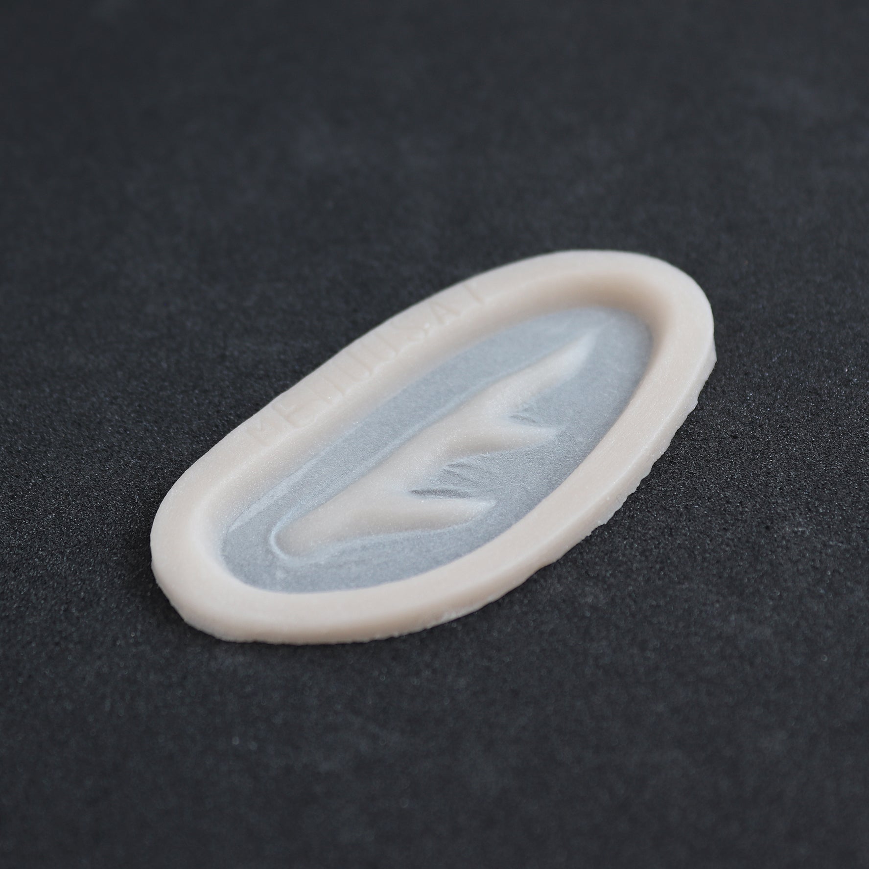 Antler Scar - Silicone makeup prosthetic in vanilla shade on a black surface