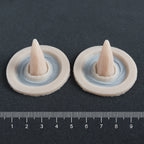 Crooked Horns (Pair) - Silicone makeup prosthetic in vanilla shade on a black surface with a ruler