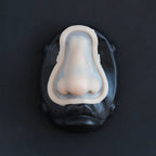 Crooked Nose - Silicone makeup prosthetic in vanilla shade on a black surface